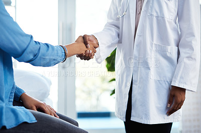 Buy stock photo Cropped shot of a doctor shaking hands with a patient in her consulting room