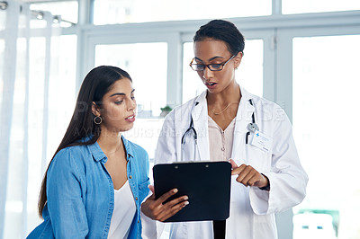 Buy stock photo Shot of a young woman having a consultation with her doctor