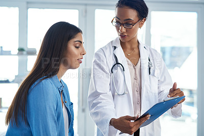 Buy stock photo Shot of a young woman having a consultation with her doctor