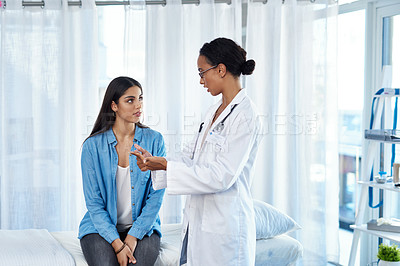 Buy stock photo Shot of a young woman having a consultation with her doctor