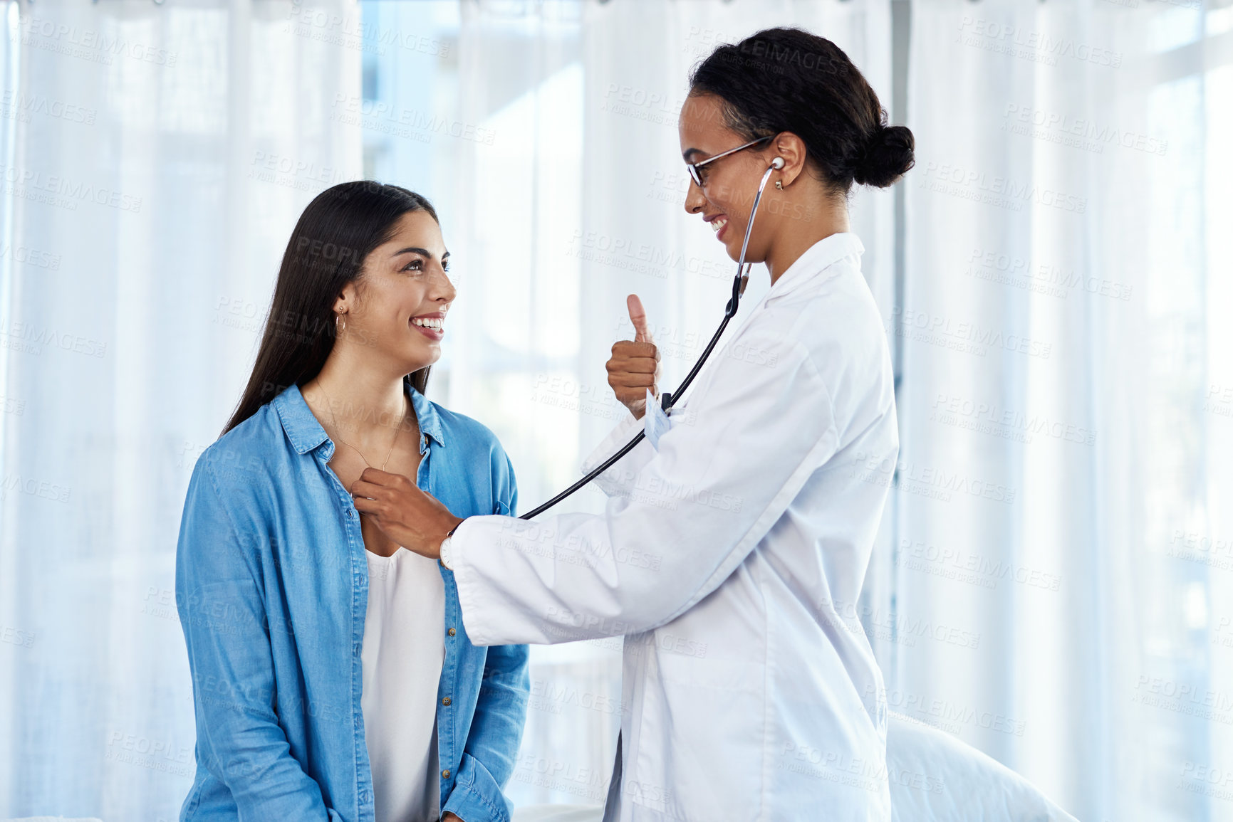 Buy stock photo Thumbs up, patient and doctor with stethoscope in examination, diagnosis or prescription. Female people, healthcare and consultation for symptoms, support and heartbeat in hospital or wellness clinic