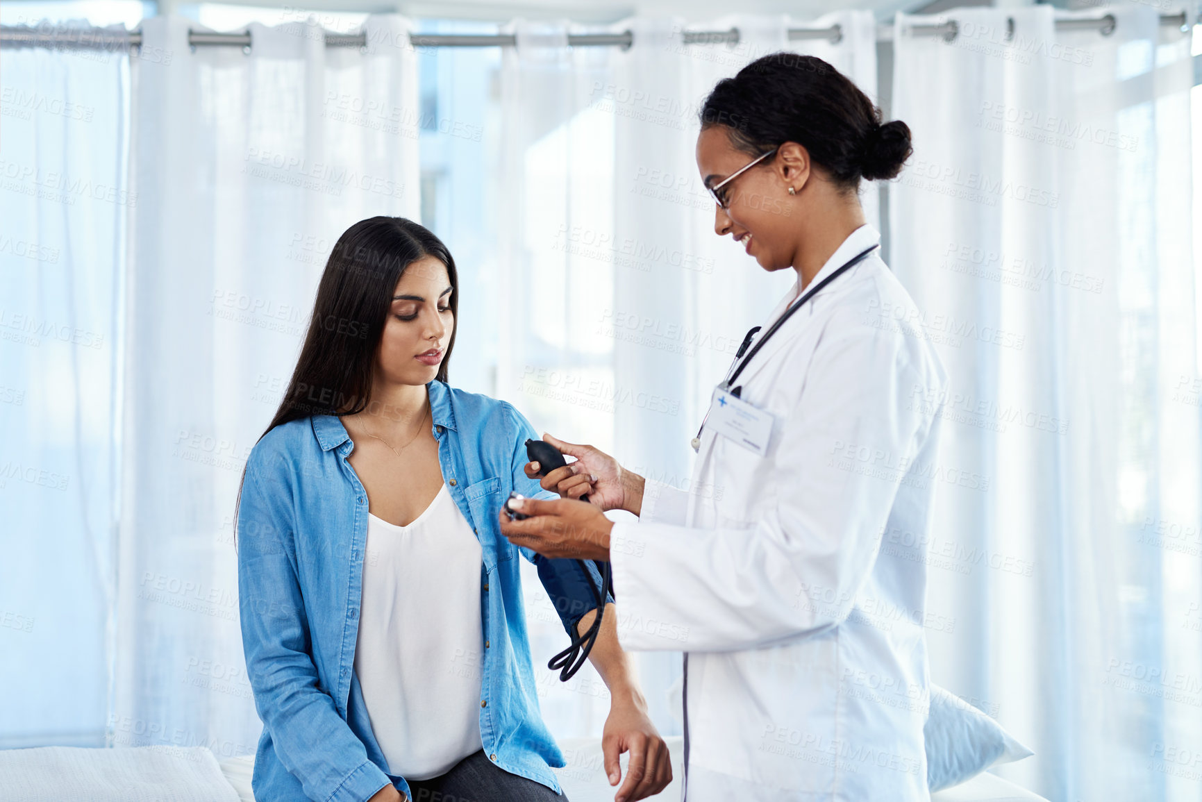 Buy stock photo Doctor, women and consultation of blood pressure at clinic for heart rate, check and hypertension of cardiology. Healthcare, patient and monitor vital signs, diagnosis and medical history of wellness