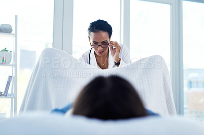 Buy stock photo Shot of a young woman having a consultation with a gynaecologist