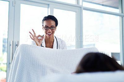 Buy stock photo Shot of a young gynaecologist giving an okay sign during a consultation with her patient