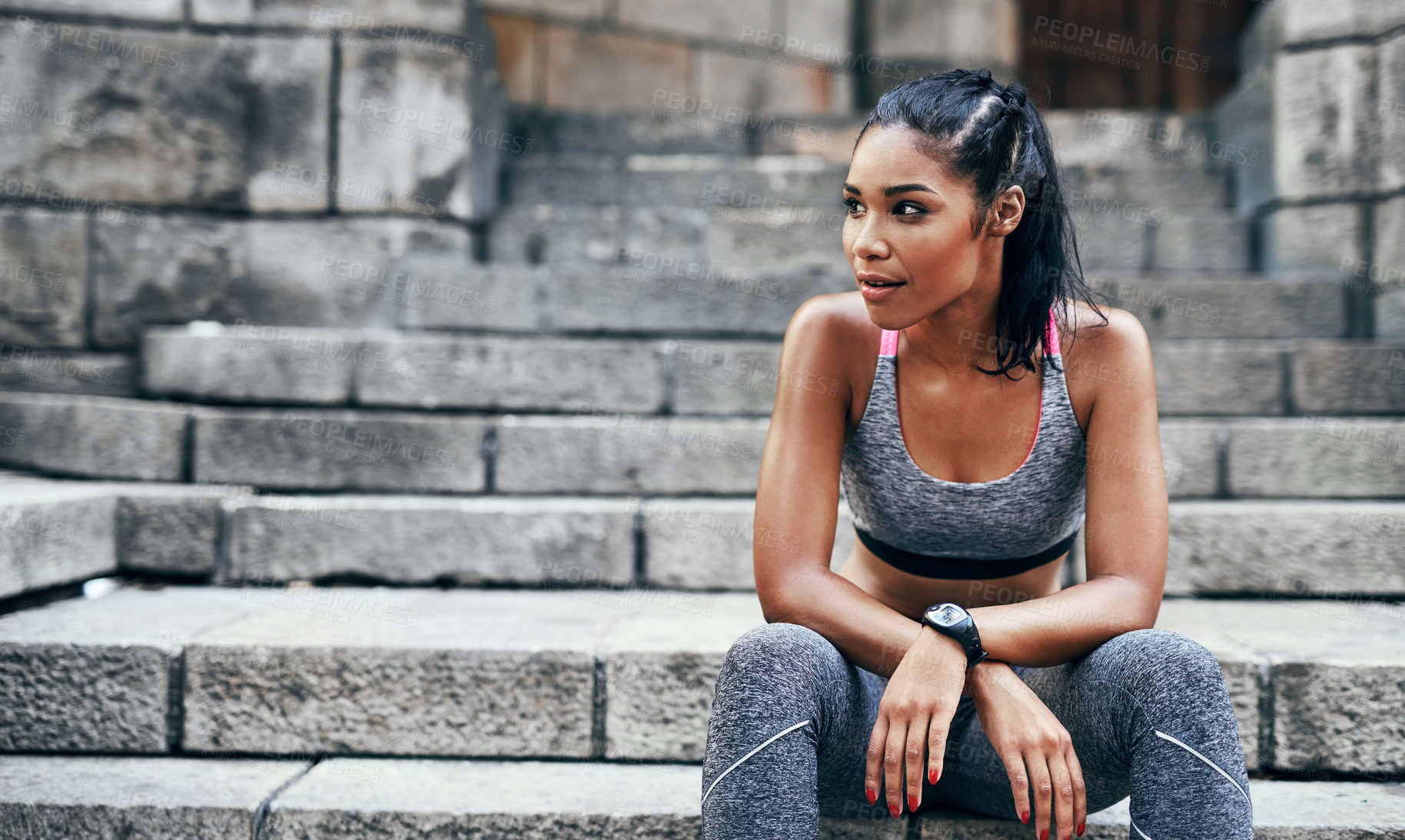 Buy stock photo Shot of an attractive young sportswoman sitting down on a stairway outdoors in the city