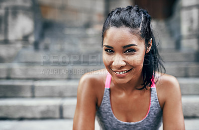 Buy stock photo Portrait of an attractive young sportswoman sitting down on a stairway outdoors in the city