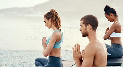 Buy stock photo Fitness, meditation and yoga with friends on beach for mental health, peace or wellness in morning. Exercise, training and zen with sporty people on mat at coast by ocean for balance or mindset