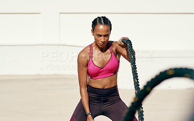 Buy stock photo Woman, fitness and battle rope exercise for physical workout, training or wellness in the outdoors. Fit, active or serious female person exercising with ropes for intense endurance, stamina or cardio