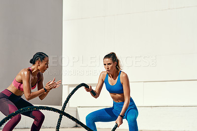 Buy stock photo Woman, personal trainer and battle rope for exercise, workout or training in fitness outdoors. Active or serious coach with female person exercising with ropes for sports motivation on mockup space