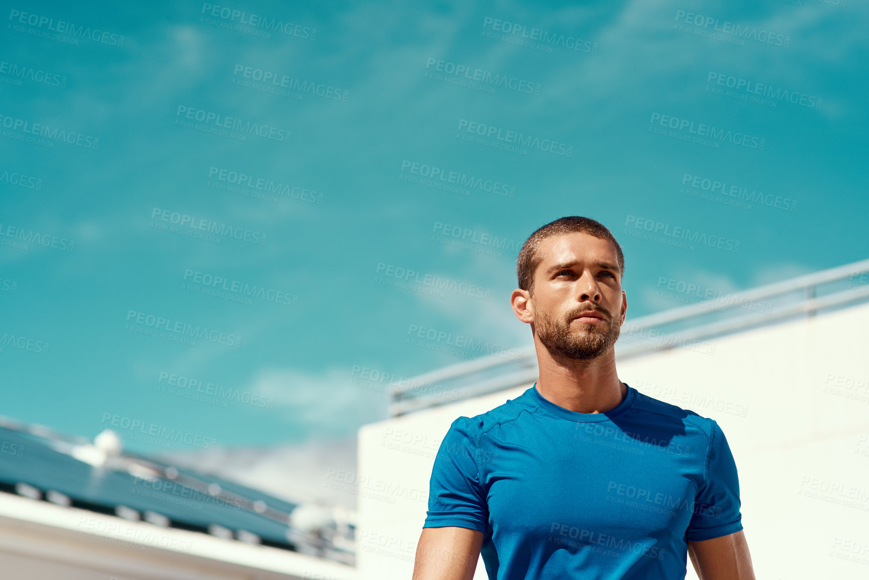 Buy stock photo Cropped shot of a sporty young man standing outside