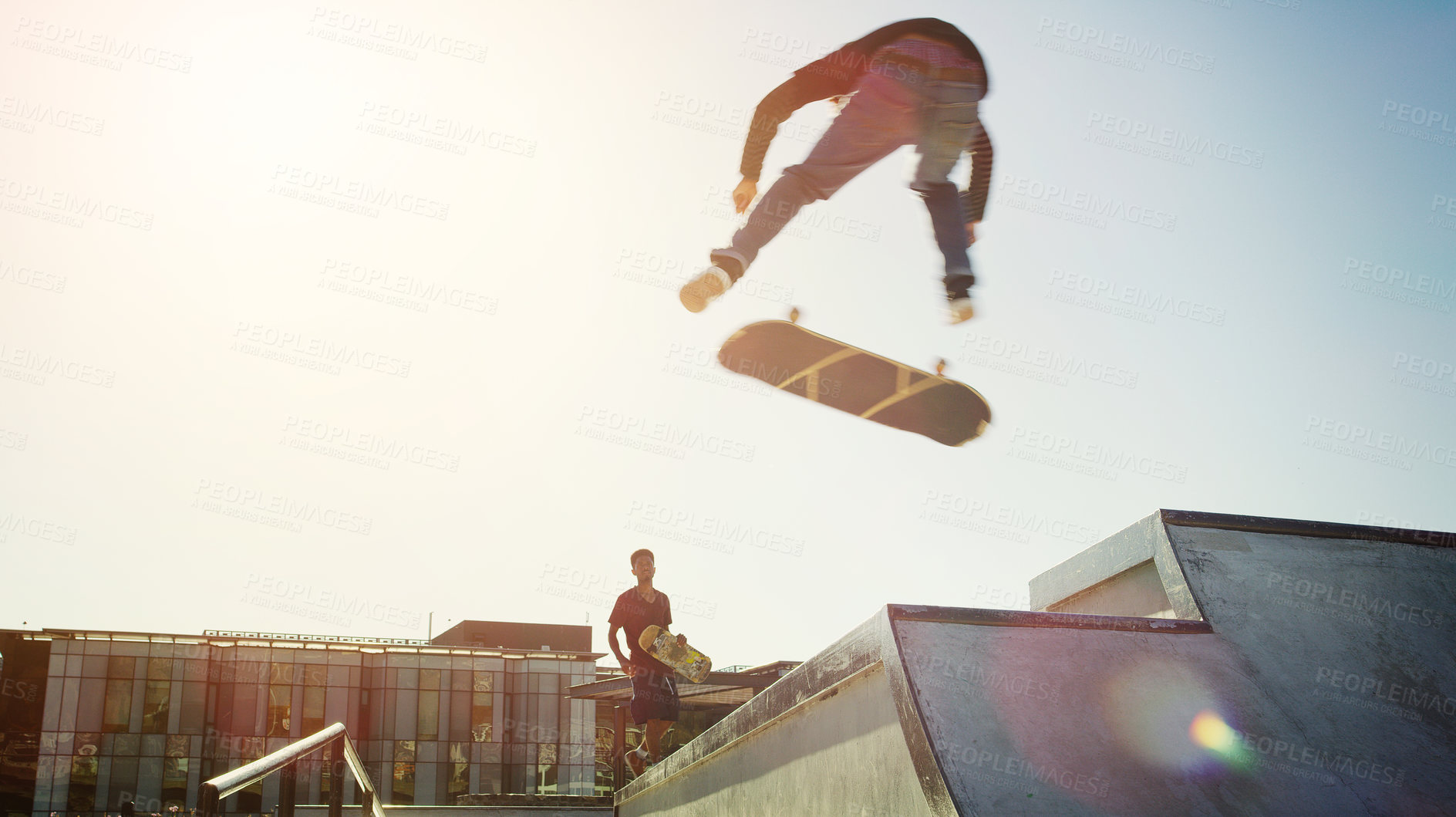 Buy stock photo Full length shot of a young man doing tricks on his skateboard at a skate park