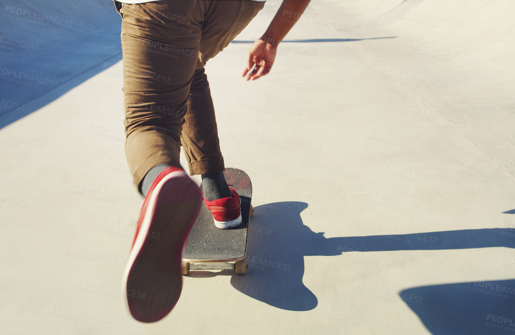 Buy stock photo Legs, person and ride skateboard outdoor for training, practice and extreme sports with action. Skateboarder, sneakers and shoes with balance at skatepark, exercise and hobby with back in summer