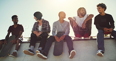 Buy stock photo Full length shot of a group of friends sitting together on a ramp at a skatepark