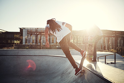 Buy stock photo Full length shot of two young men skating together on their skateboards at a skate park