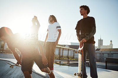 Buy stock photo Full length shot of a group of friends skating together on their skateboards at a skatepark