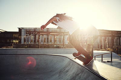 Buy stock photo Shot of two young men skating together on their skateboards at a skate park