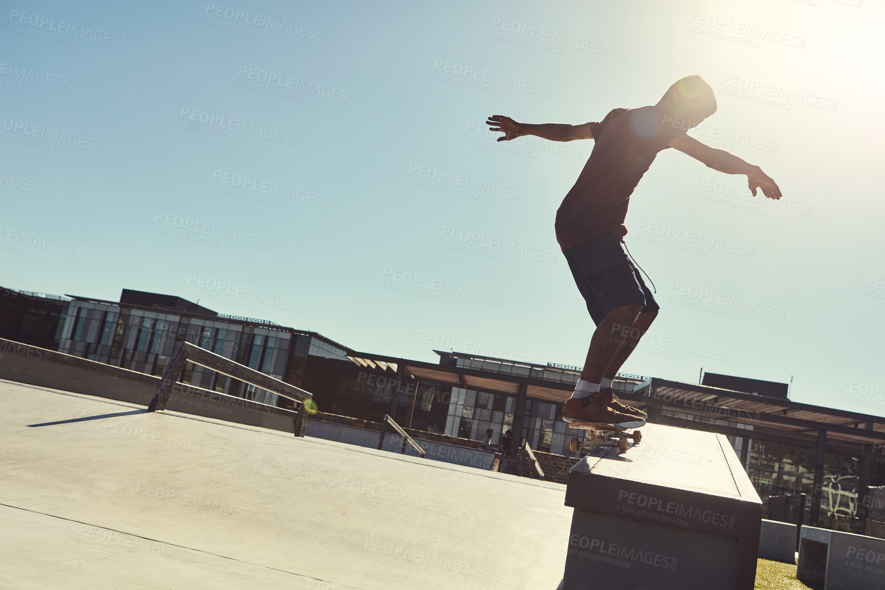 Buy stock photo Full length shot of a young man doing tricks on his skateboard at a skate park