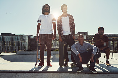 Buy stock photo Full length shot of a group of friends standing together on a ramp at a skatepark