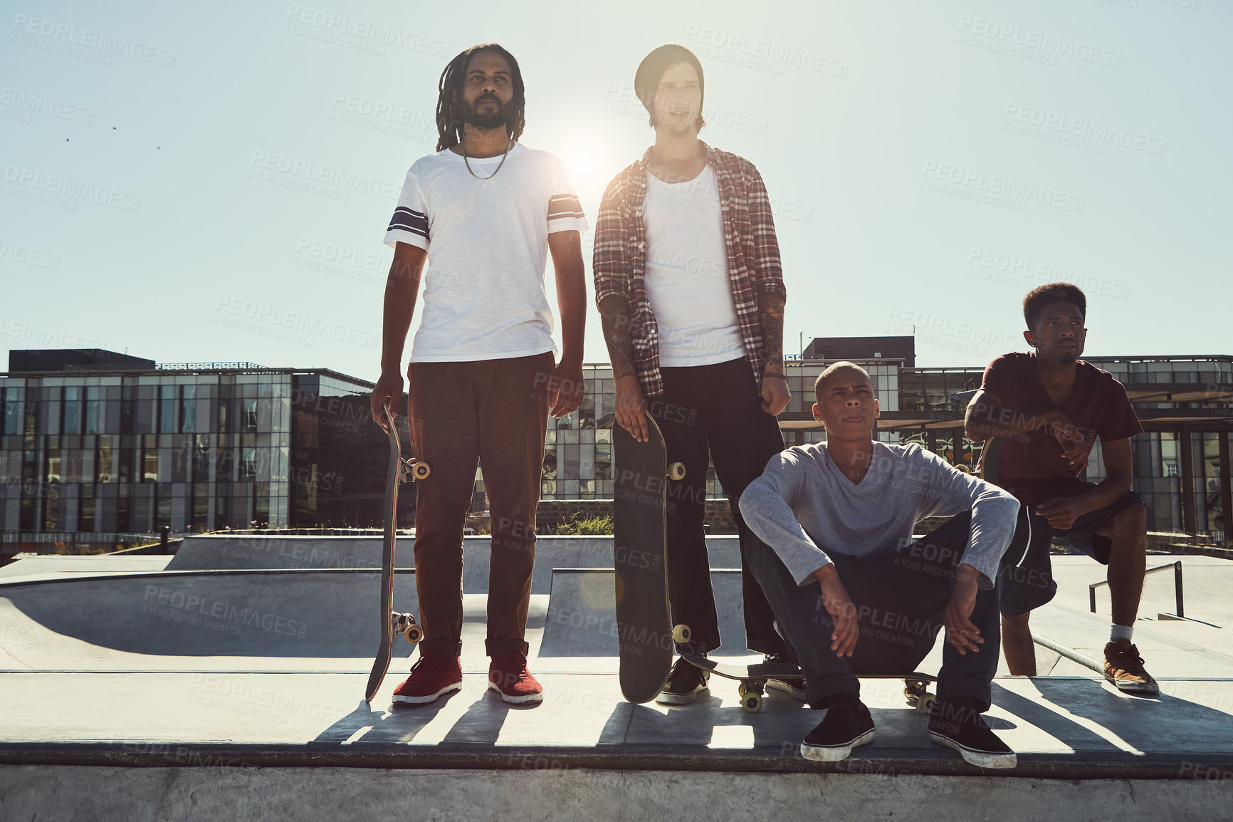 Buy stock photo Full length shot of a group of friends standing together on a ramp at a skatepark