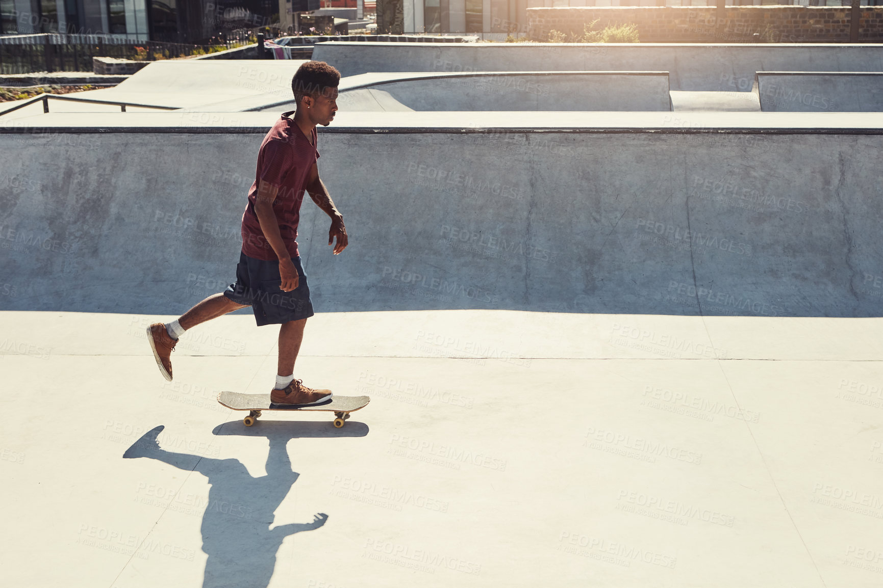 Buy stock photo Full length shot of a young man doing tricks on his skateboard at a skate park