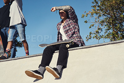 Buy stock photo Shot of a group of friends enjoying themselves at a skate park