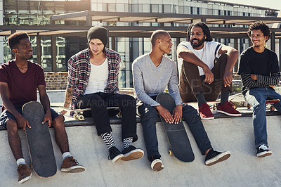 Buy stock photo Full length shot of a group of young skaters sitting together on a ramp at a skatepark