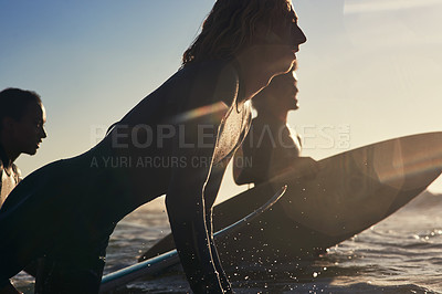 Buy stock photo Shot of a group of young surfers surfing together in the ocean