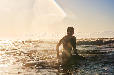 Buy stock photo Rearview shot of a young man surfing in the ocean