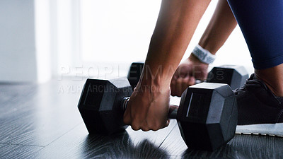 Buy stock photo Cropped shot of a woman working out with dumbbells in a gym