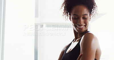 Buy stock photo Shot of a confident young woman working out in a gym