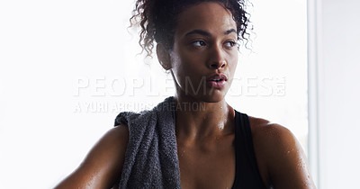 Buy stock photo Shot of a young woman taking a break from her workout in a gym