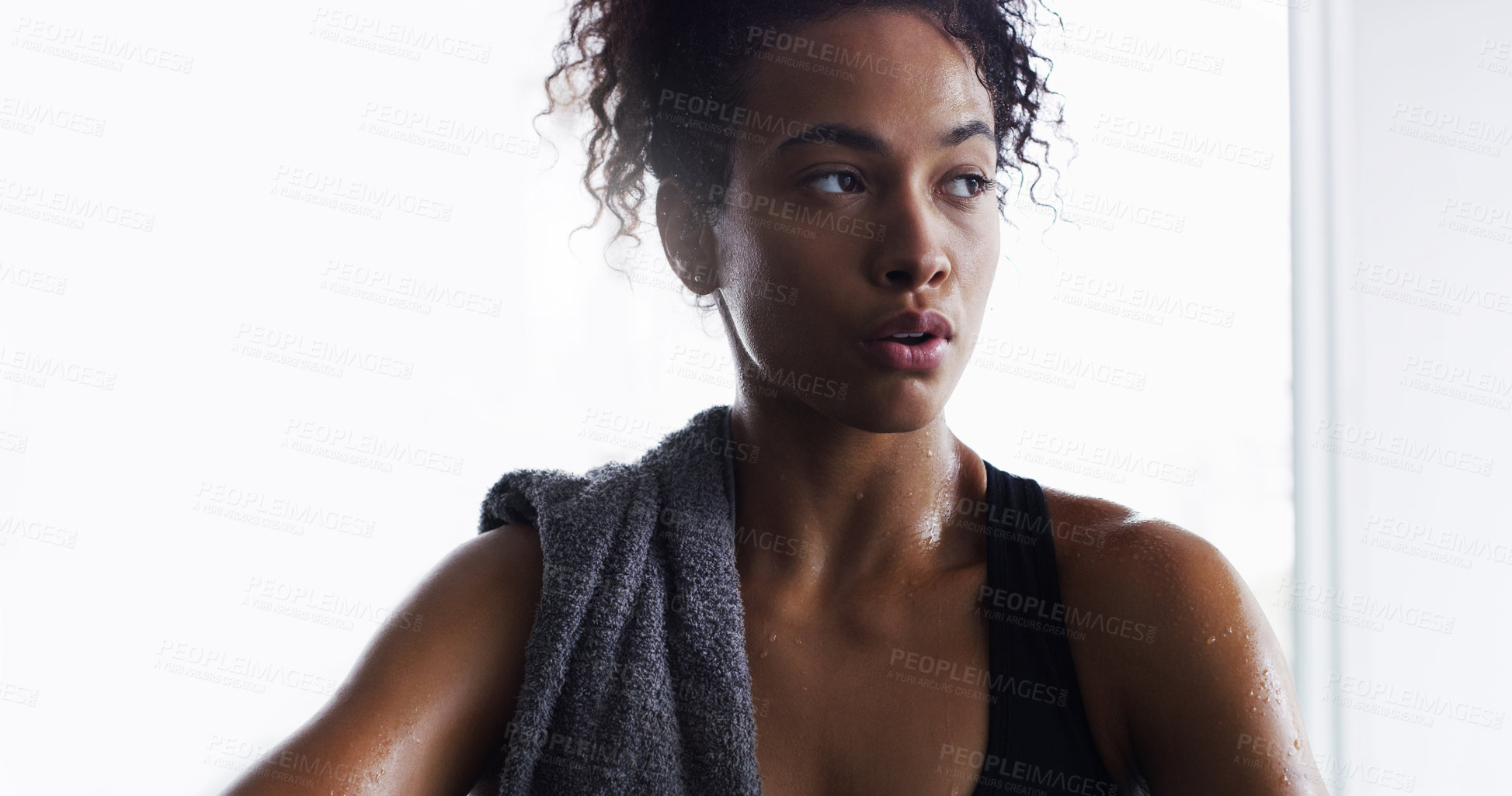 Buy stock photo Shot of a young woman taking a break from her workout in a gym