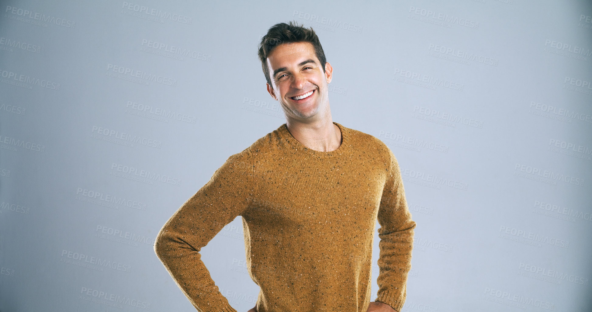 Buy stock photo Studio shot of a confident and handsome young man posing against a gray background