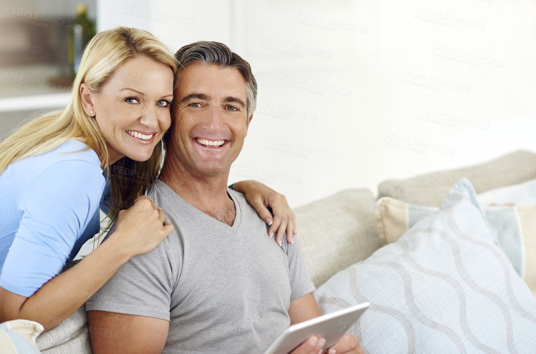 Buy stock photo Lounge, smile and couple with tablet, portrait and watch of movie, choice and subscription for entertainment. House, man and woman with app, streaming and happy in living room, scroll and bonding