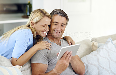 Buy stock photo Lounge, relax and couple with tablet, app and browsing of movie, showing and subscription for entertainment. House, watch and woman with man, streaming and happy in living room, scroll and bonding