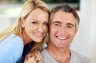 Buy stock photo Cropped portrait of an affectionate mature couple smiling at home