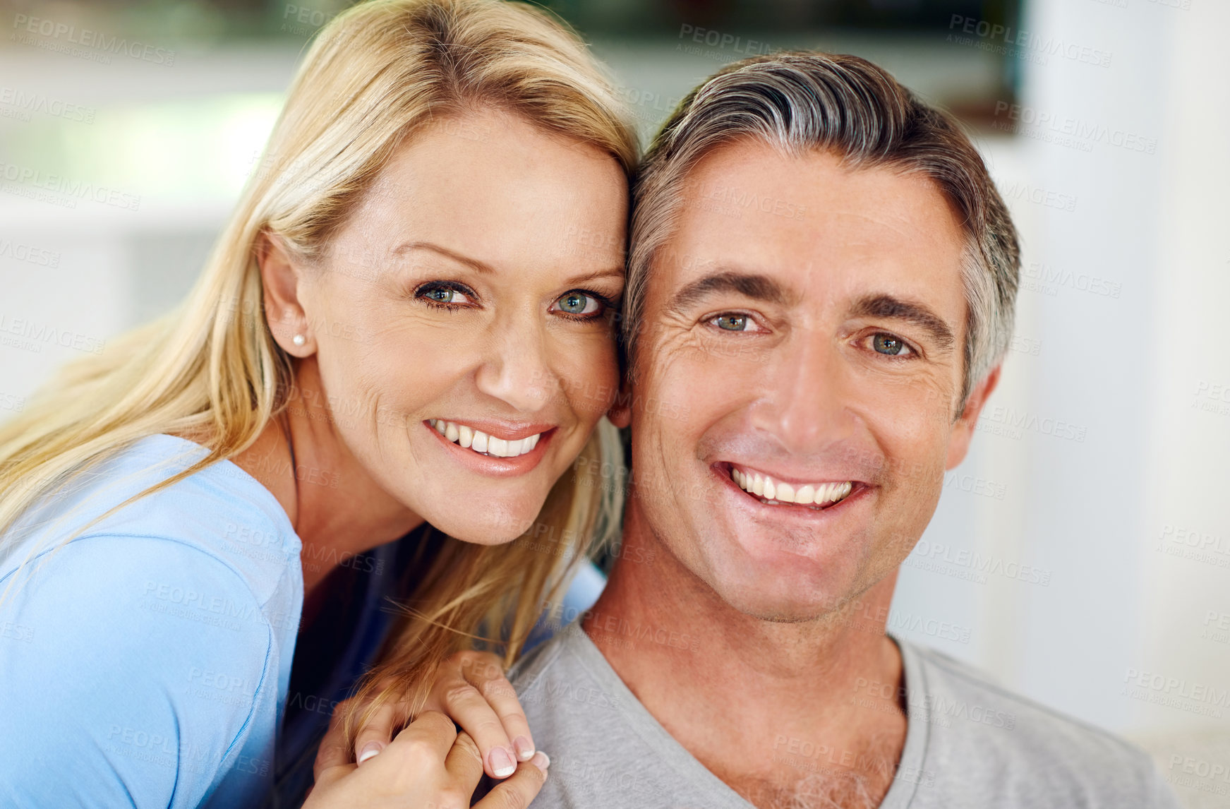 Buy stock photo Cropped portrait of an affectionate mature couple smiling at home