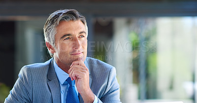 Buy stock photo Cropped shot of a handsome mature businessman looking thoughtful while working outdoors