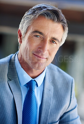 Buy stock photo Cropped portrait of a handsome mature businessman looking confident while working outdoors