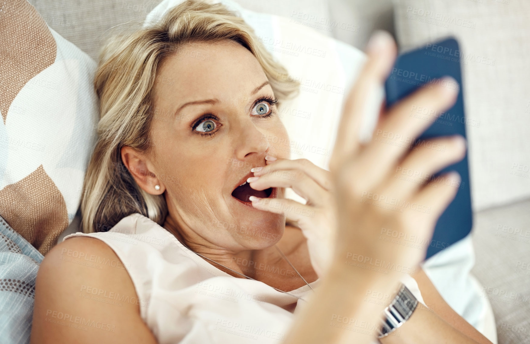 Buy stock photo Mature woman, phone and surprise on couch with shock for reading, contact or announcement on mobile app in lounge. Person, chat and smartphone for social network, news and wow on sofa in house