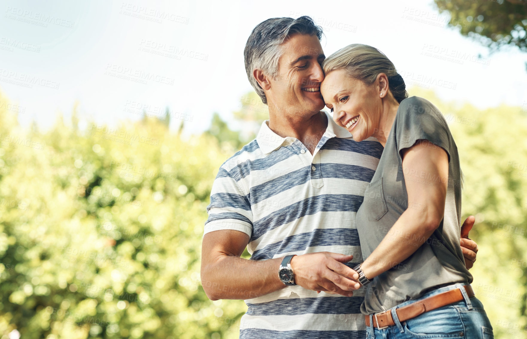 Buy stock photo Happy, hug and couple in park walking for bonding, relationship and relax in morning outdoors. Nature, marriage and mature man and woman laughing for romance, affection and love on weekend together