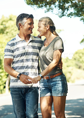 Buy stock photo Happy, holding hands and couple in street walking for bonding, relationship and love outdoors. Nature, marriage and man and woman laugh in park for romance, affection and relax on weekend together