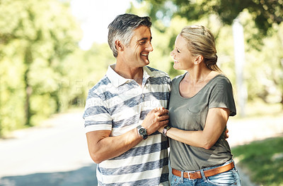 Buy stock photo Happy, holding hands and couple in street walking for bonding, relationship and love outdoors. Nature, marriage and man and woman laugh in park for romance, affection and relax on weekend together