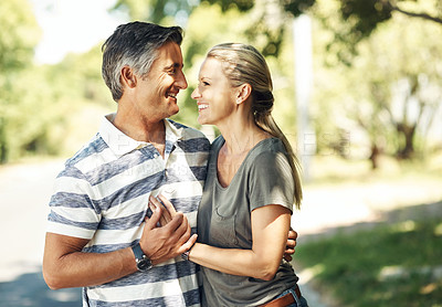 Buy stock photo Cropped shot of an affectionate mature couple enjoying a day in the park