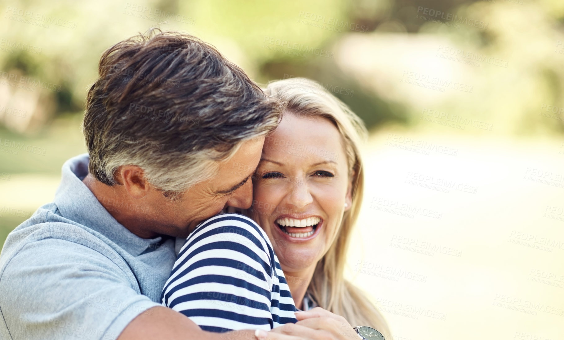 Buy stock photo Cropped shot of an affectionate mature couple enjoying a day in the park