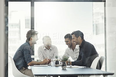 Buy stock photo Cropped shot of a group of businessmen having a meeting around a table in an office