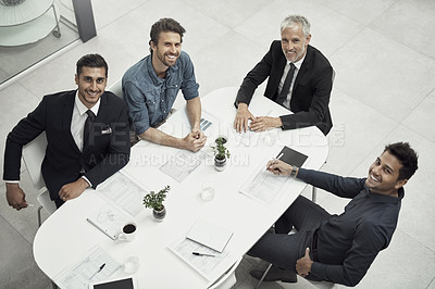 Buy stock photo High angle portrait of a group of businessmen having a meeting around a table in an office