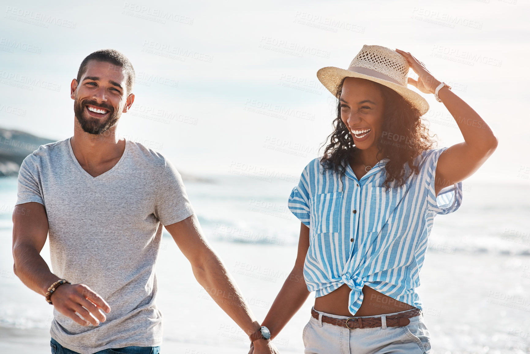 Buy stock photo Love, walk and holding hands with couple, beach and happy relationship for anniversary on holiday together. Romance, African man and woman with ocean, laugh and bonding with sunset on vacation