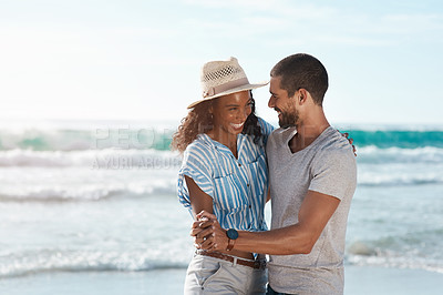 Buy stock photo Shot of a young couple dancing together at the beach