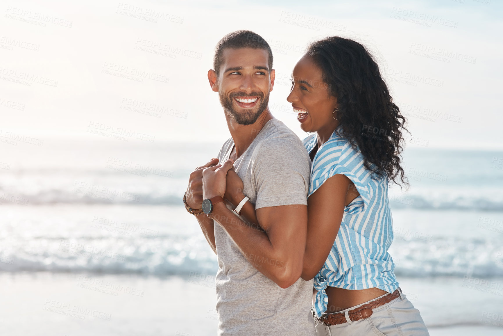 Buy stock photo Love, couple or happy on beach with hug, travel or support in relationship. Man, woman or affection at ocean for summer vacation, holiday or commitment with milestone or engagement in California